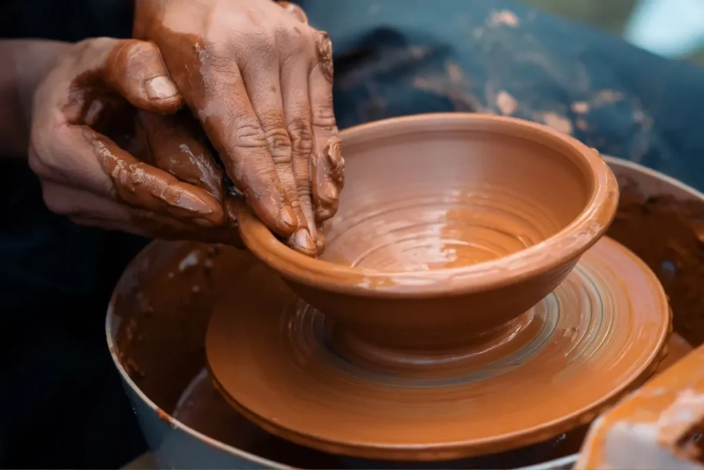 Turning a brown bowl by hand