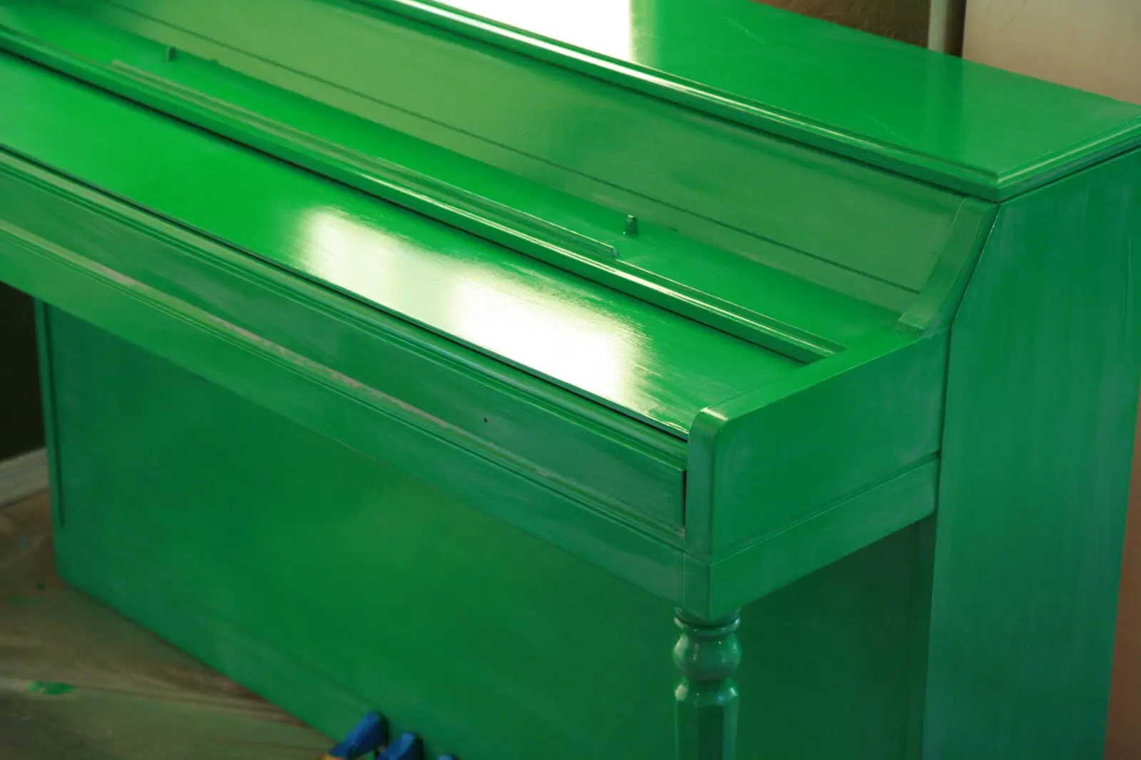 Wood piano painted with oil based green paint